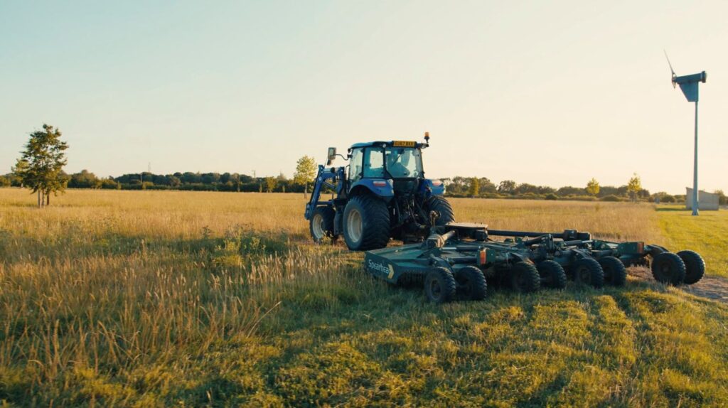 A tractor tending to a wildflower meadow, one example of a habitat for BNG