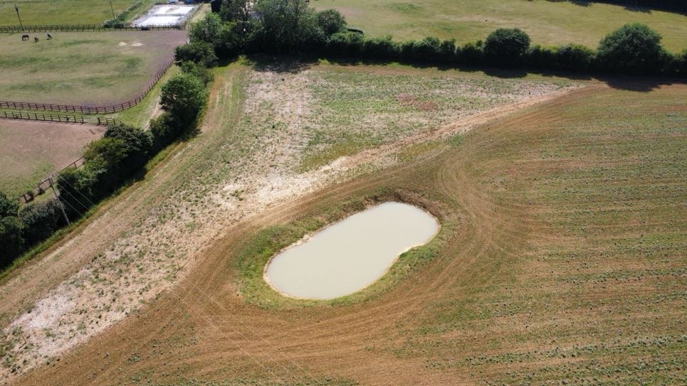 A drone shot of Glebe Land, including a pond - one habitat type for BNG.